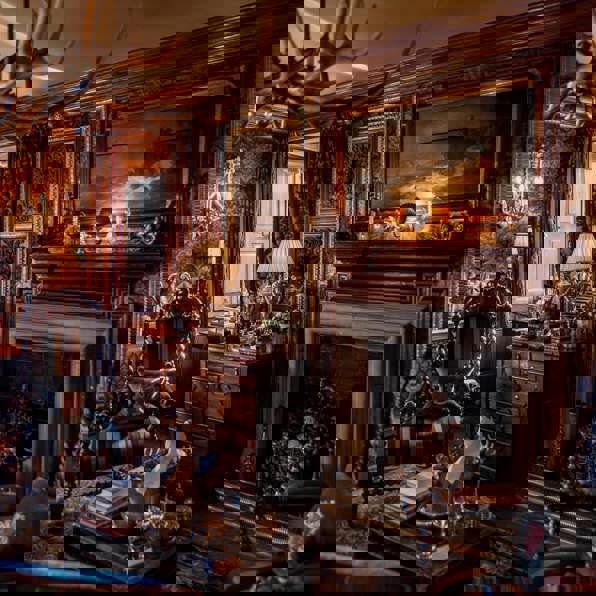 Ornate wood panelling and antique furnishings in the Owners Suite at Prestonfield House 5 Star Edinburgh hotel