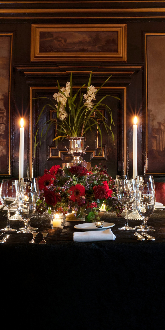 Table set with candles and paintings in the grand Italian private dining room at Prestonfield House Hotel Edinburgh 