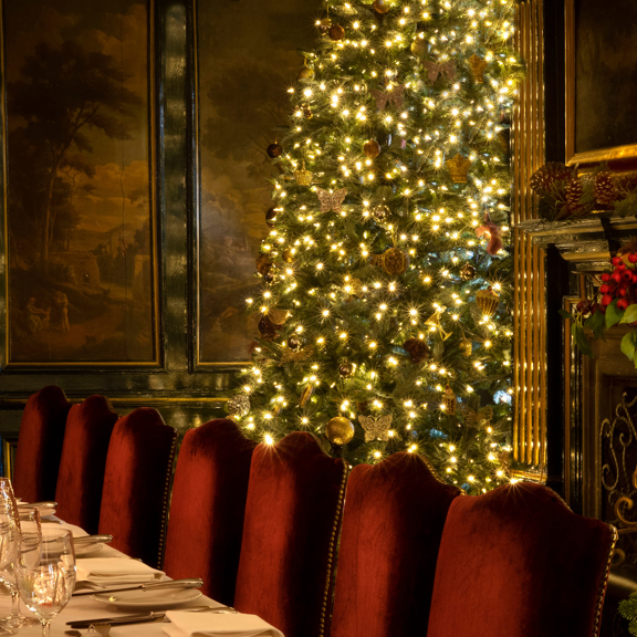 Grand Christmas tree and laid out table during December Edinburgh hotel break at luxury hotel Prestonfield House