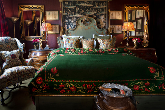 Green velvet bedding, Champagne and antiques in Room 16 at Prestonfield House 5 star hotel
